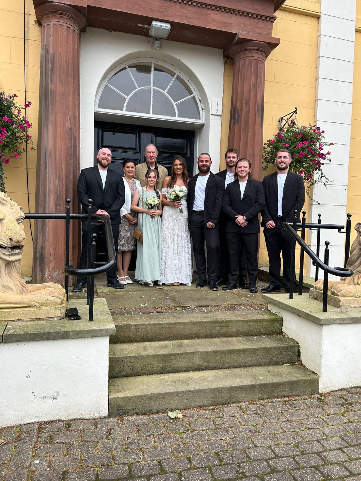 Wedding guests with bride and groom